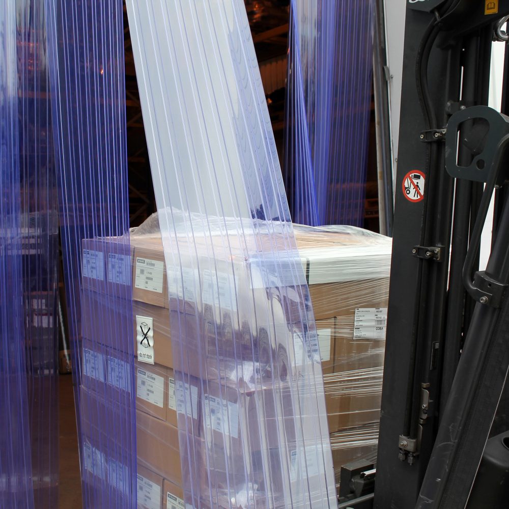 Forklift-truck-driving-packages- through-a-Buffer-Ribbed-PVC-Strip- Curtain-from-outside