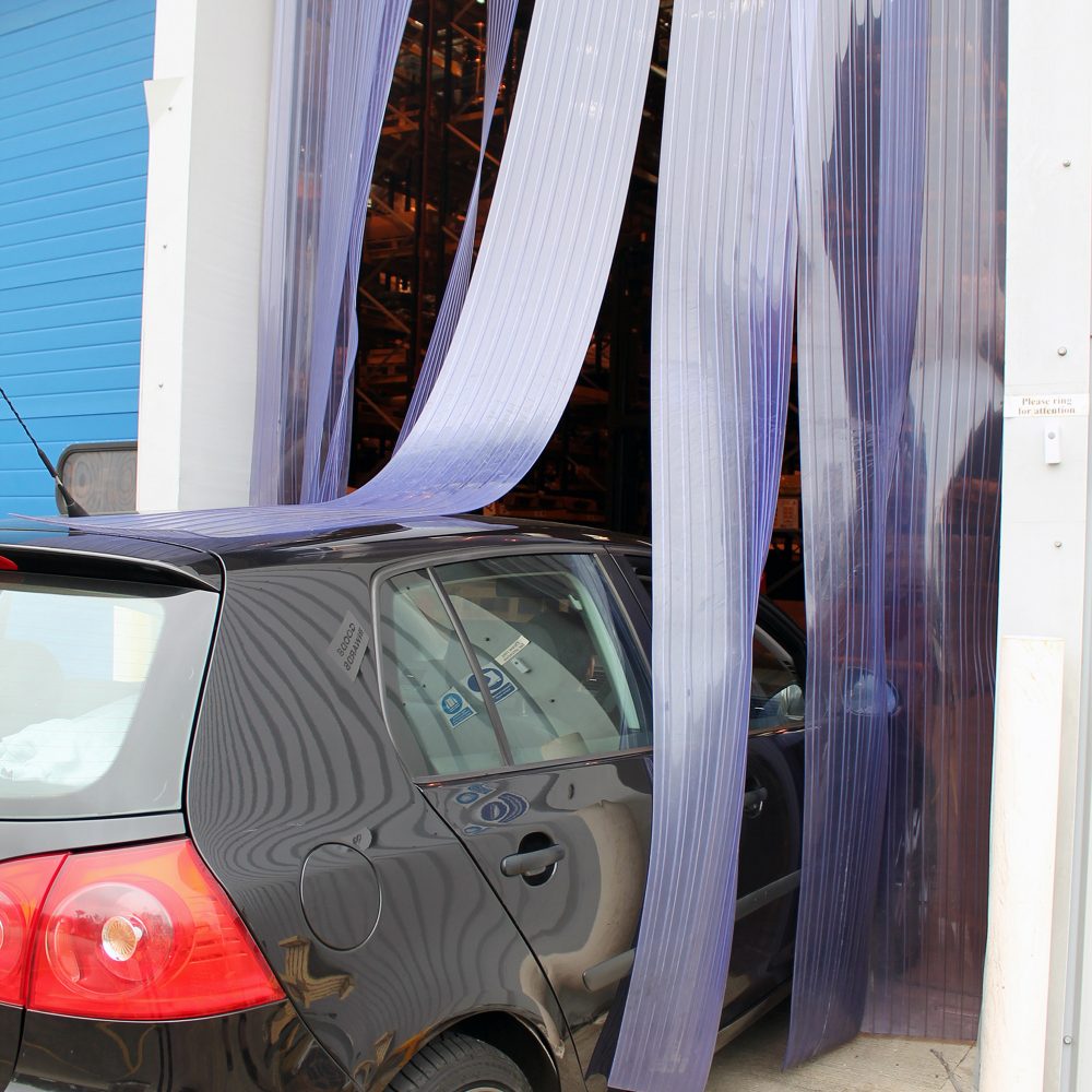 Car-reversing-outside-of-a-building- through-Buffer-Ribbed-PVC-Strip- Curtains