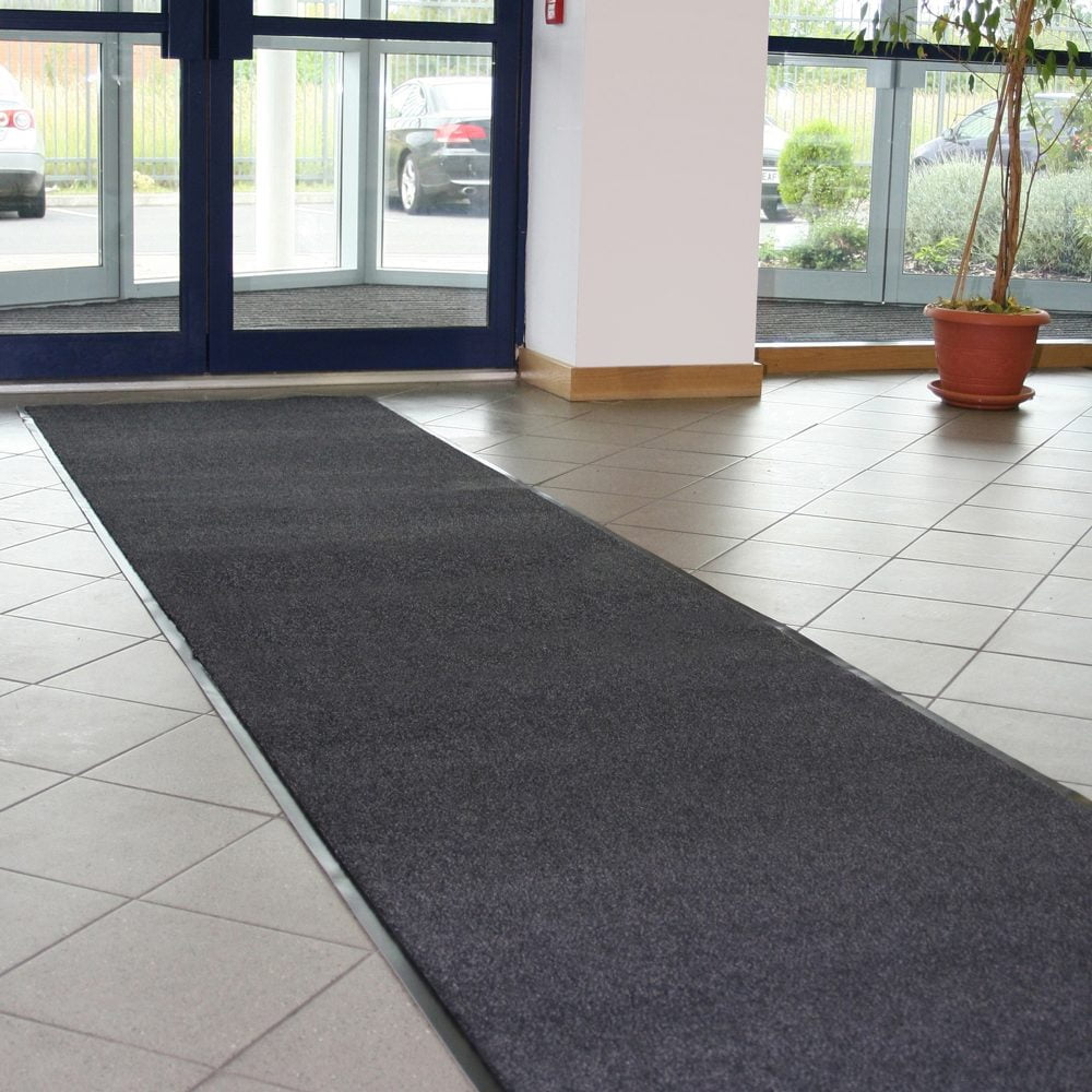 Image-of-a-strip-of-alba-entrance-mat- inside-of-an-entrance-on-a-tiled-floor