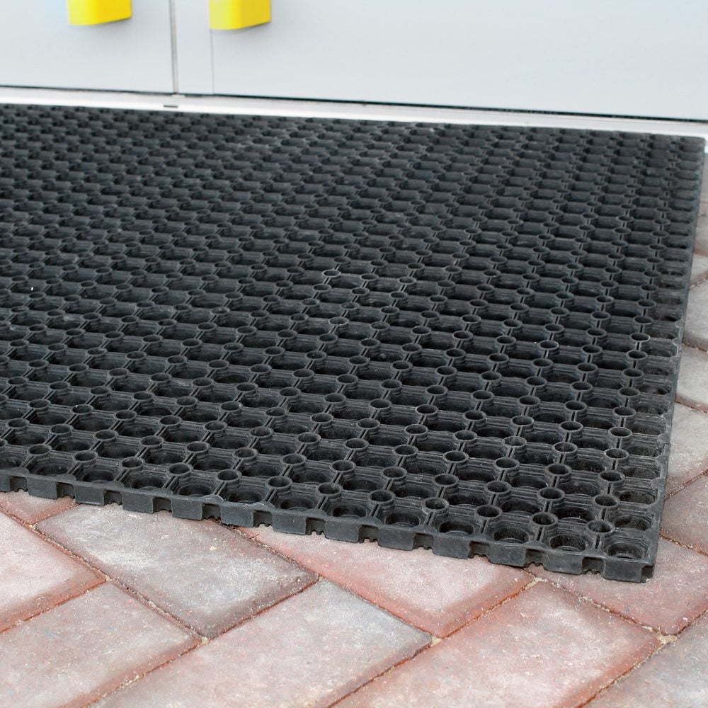 Image-of-a-black-rubber-Ringmat- Honeycomb-placed-outside-on-brick- flooring