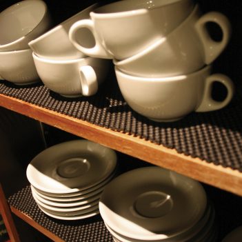 mugs-and-saucers-stacked-on-a-surface-of-anti-slip-gripsafe-material